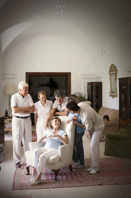 View of an elderly woman surrounded by her family.