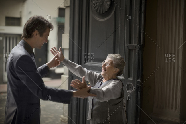 View of an elderly lady embracing her son.