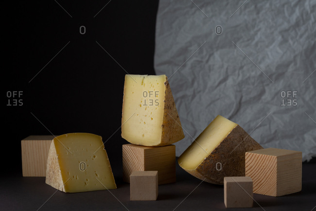 Aged swiss cheese wedges on wooden blocks