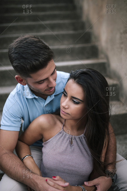 Couple in love hugging on a stone staircase