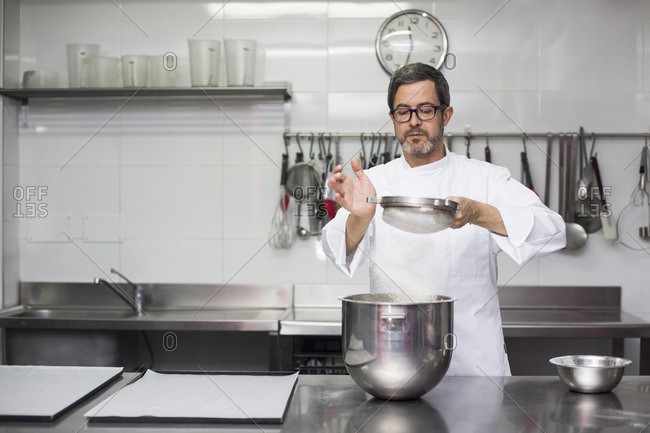Chef sifting flour into bowl