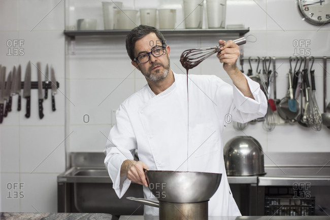 Chef melting chocolate with water bath