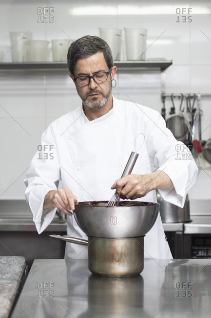 Chef using bain marie in kitchen