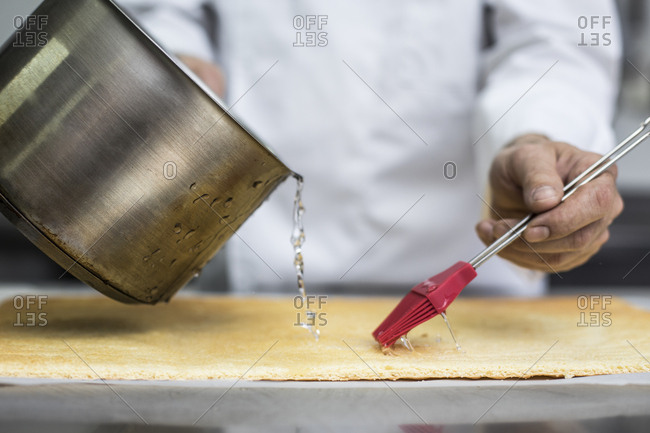 Chef soaking biscuit with syrup