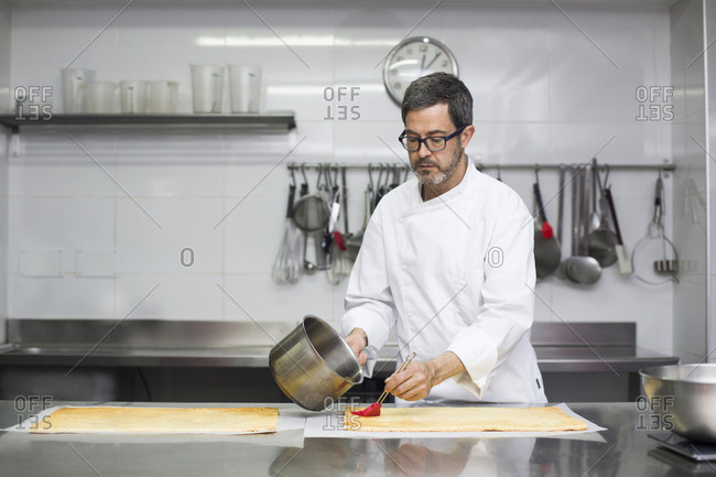 Chef soaking biscuit with syrup making pastry