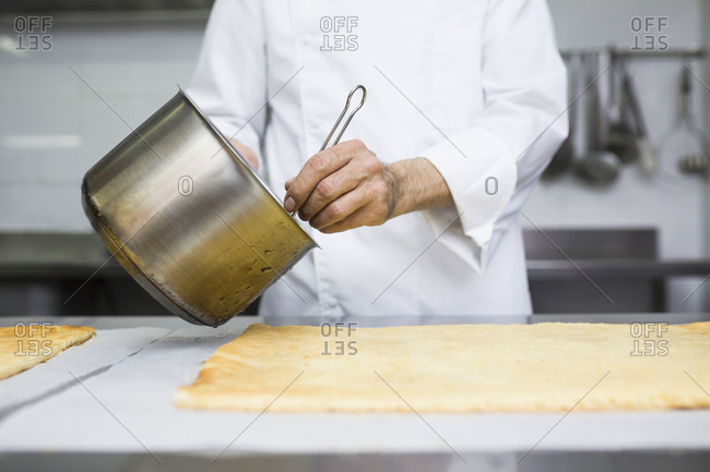 Chef soaking biscuit with syrup