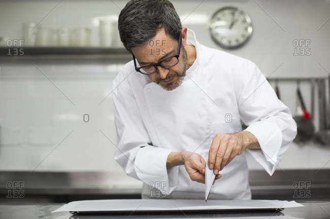 Chef making decorations with pastry bag