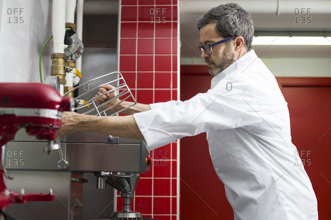 Chef preparing a mixer machine in a kitchen