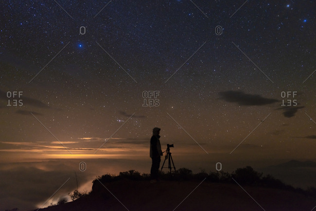 Man photographing the starry sky after sunset