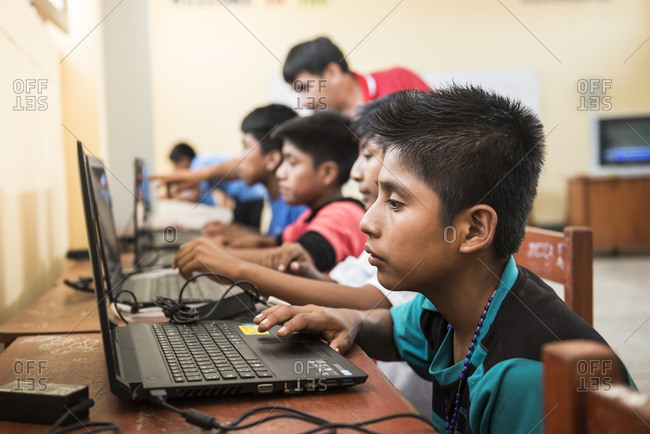 Lambayeque, Peru - June 10, 2015: Peruvian children learning English using computers in a classroom