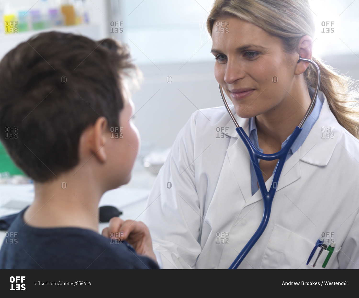 Female doctor listening to a boys heart beat using a stethoscope during a health check in a clinic