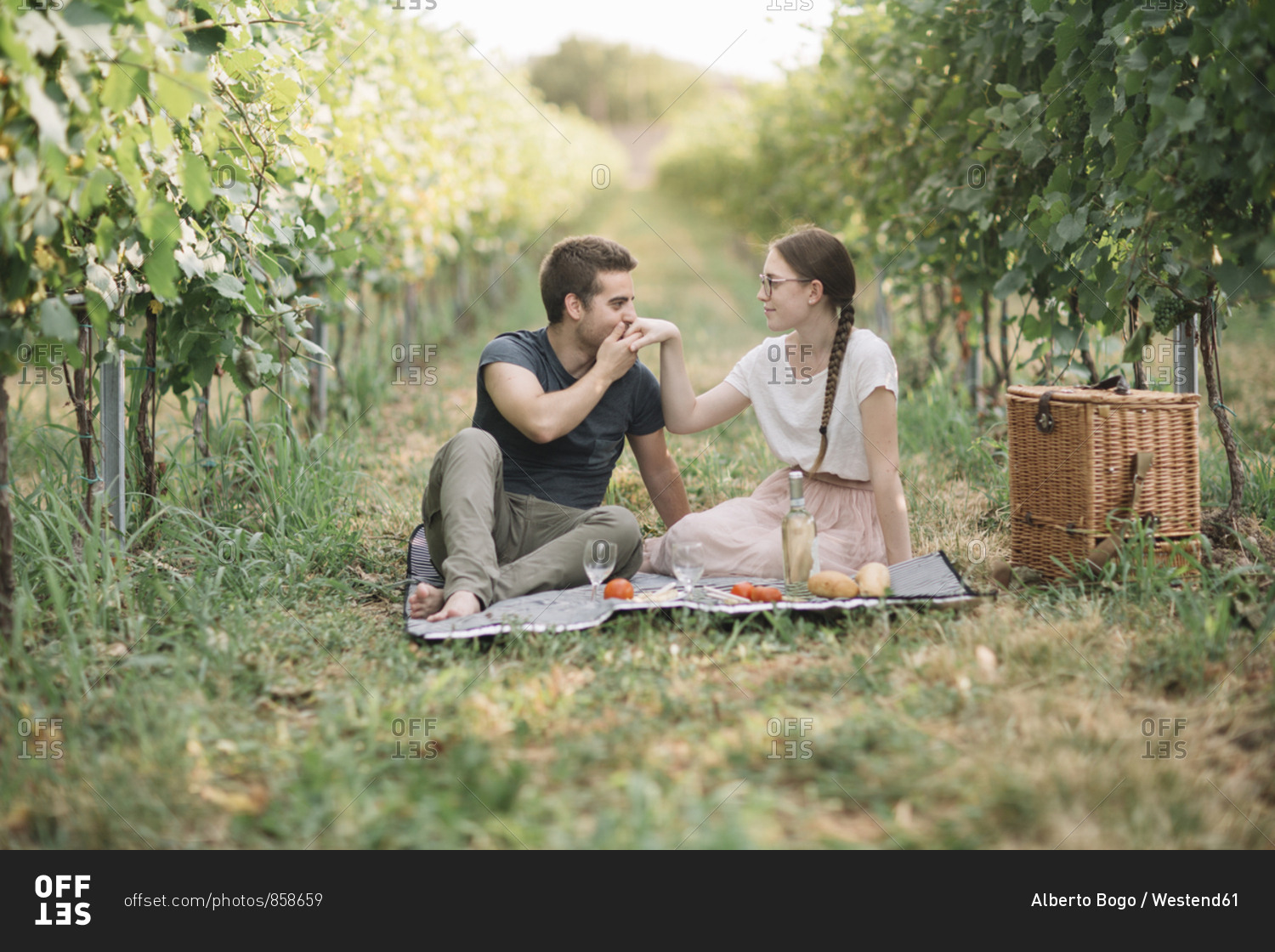 Young couple in love having picnic in the vineyards