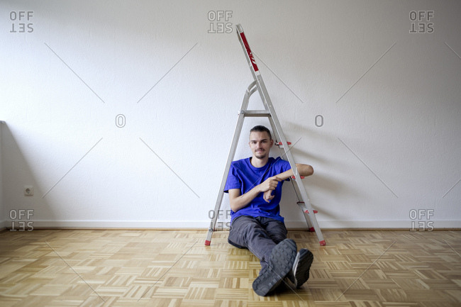 Young man sitting in an empty apartment