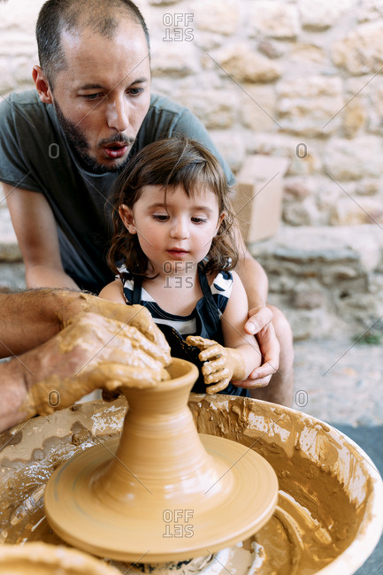 Father and daughter in a pottery workshop