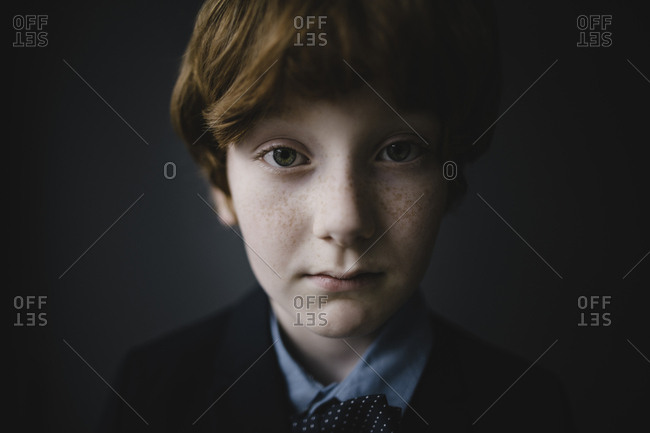 Portrait of sad boy with freckles