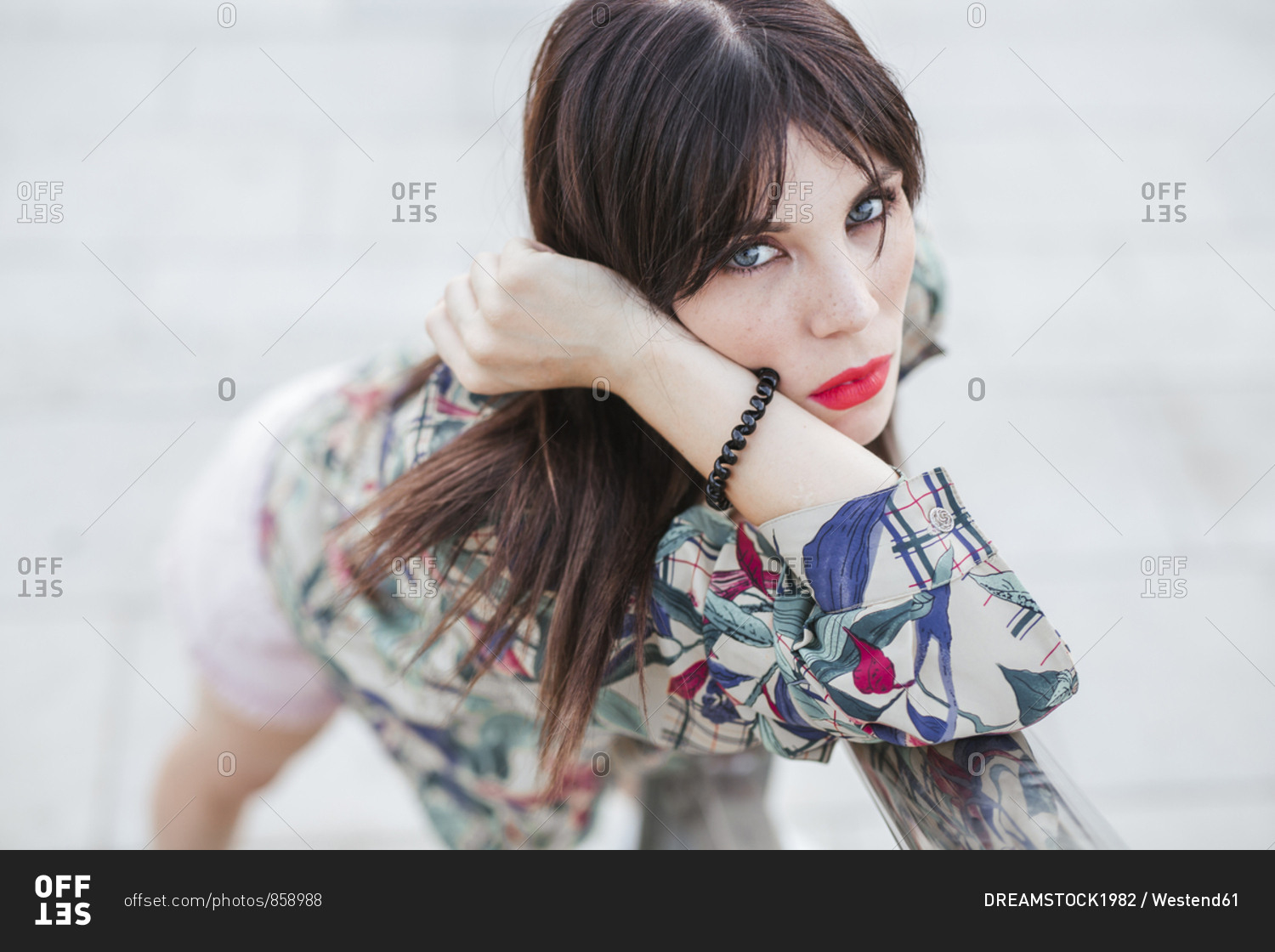Portrait of young woman posing wearing patterned blouse