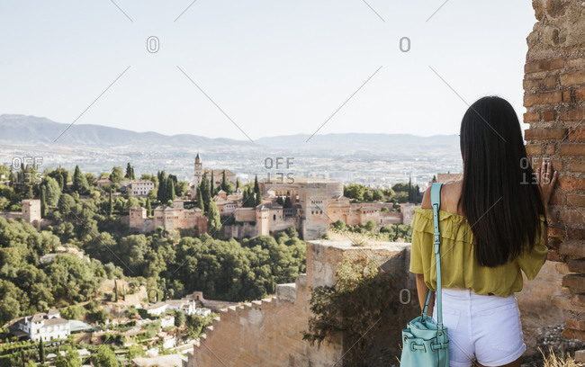 Rear view of young woman looking at the Alhambra- Granada- Spain