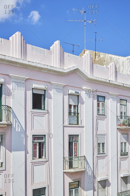 Pastel pink apartment building in Bairro das Colonias in the Anjos neighborhood, Lisbon, Portugal