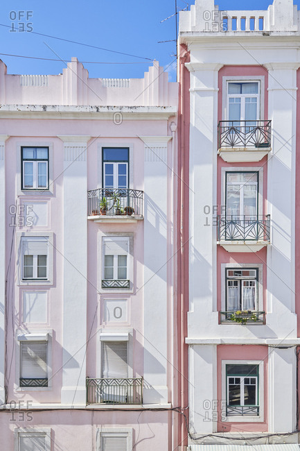 Pink facade of apartment building in Bairro das Colonias in the Anjos neighborhood, Lisbon, Portugal