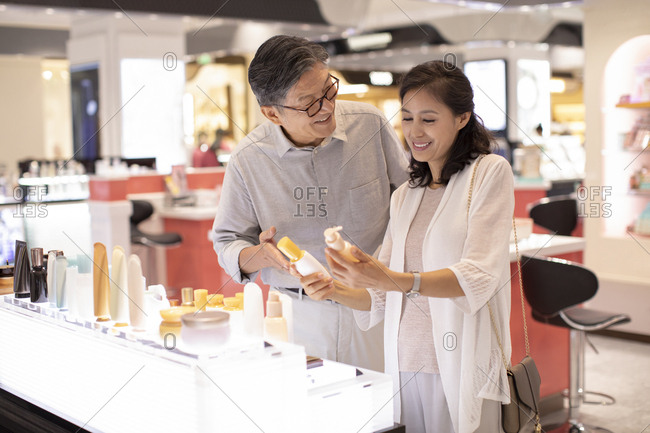 Mature Chinese couple shopping in shopping mall