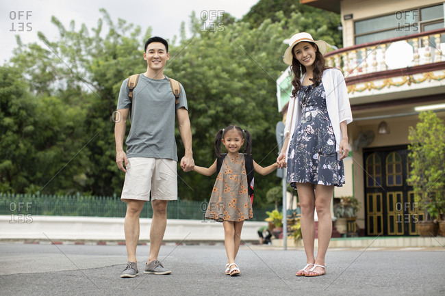 Happy young Chinese family enjoying vacation