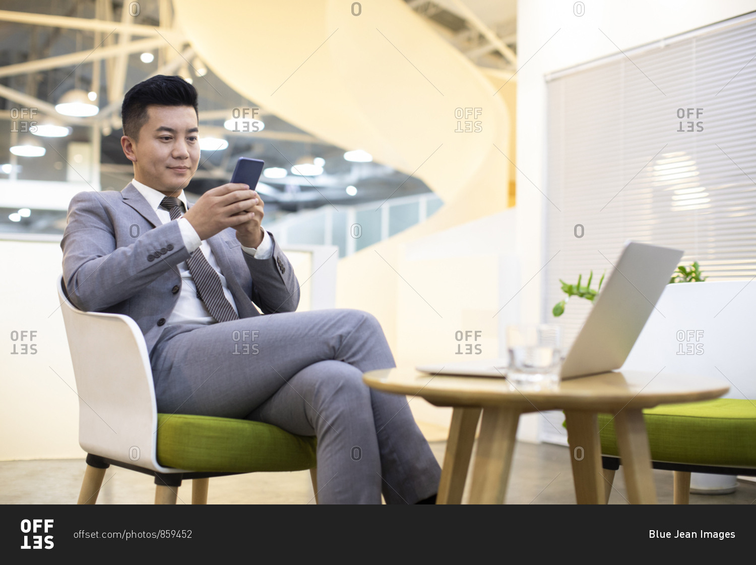 Chinese businessman using smartphone in office
