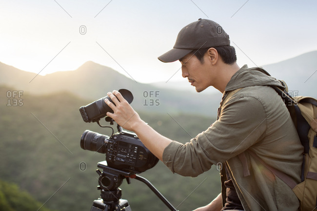 Chinese photographer taking photos outdoors