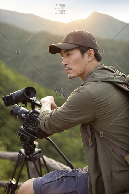 Chinese photographer taking photos outdoors