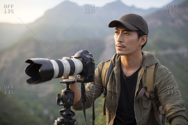 Chinese photographer taking photos outdoors