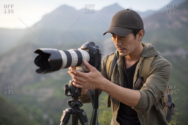 Chinese photographer taking photos outdoors
