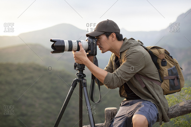 Chinese photographer taking photos outdoors