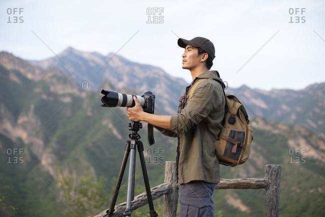 Chinese photographer taking photos outdoors