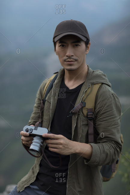 Chinese photographer taking photos outdoors