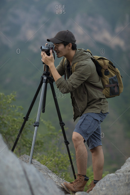 Chinese photographer taking photos outdoors