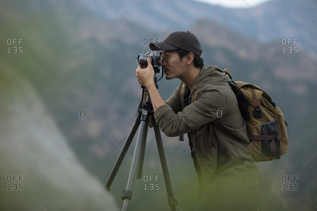 Chinese photographer taking photos outdoors