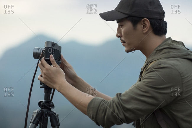 Chinese photographer taking photos outdoors