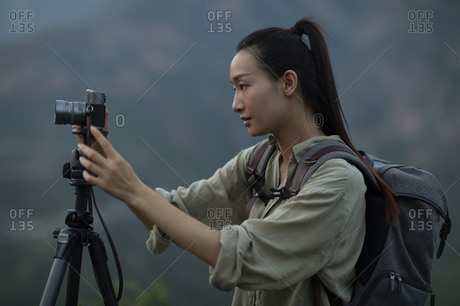 Chinese photographer taking photos outdoors