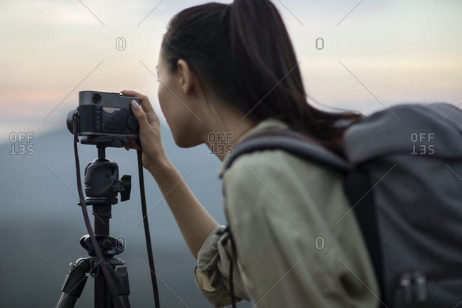 Chinese photographer taking photos outdoors