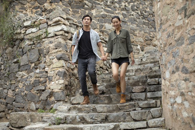 Young Chinese couple hiking in village