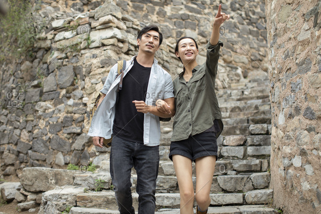 Young Chinese couple hiking in village