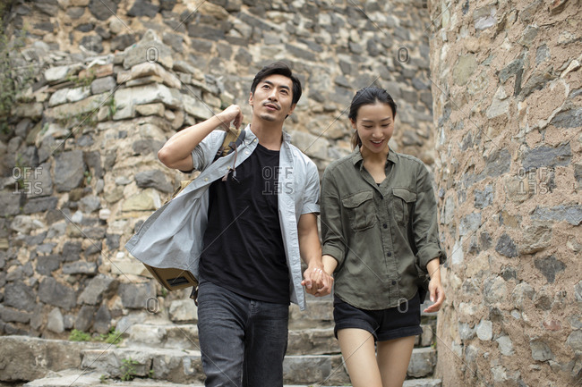 Young Chinese couple hiking in village