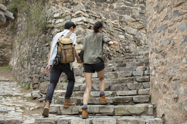 Young Chinese couple hiking in village