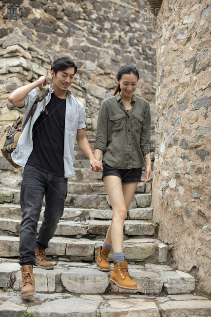 Young Chinese couple hiking in village
