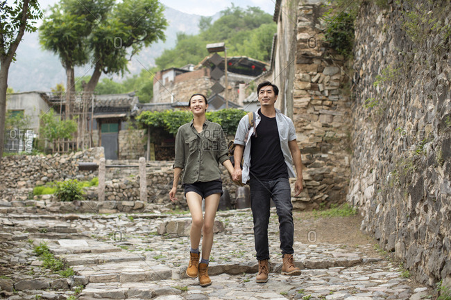 Young Chinese couple hiking in village
