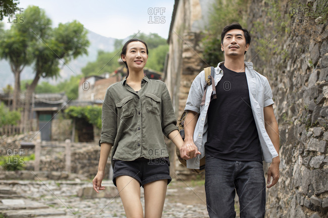Young Chinese couple hiking in village