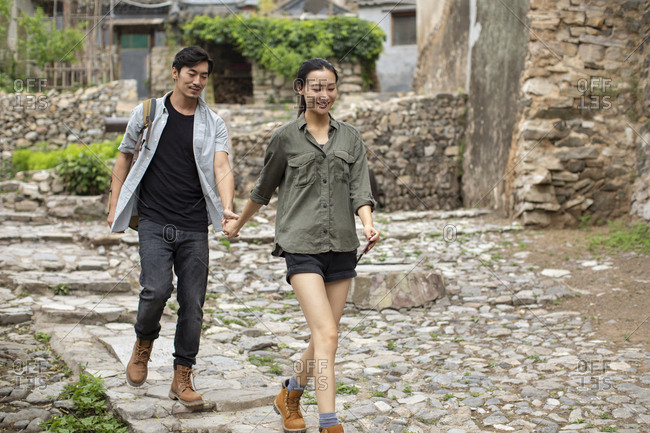 Young Chinese couple hiking in village