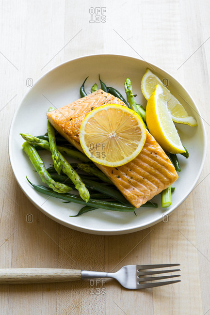 Grilled salmon served over vegetables