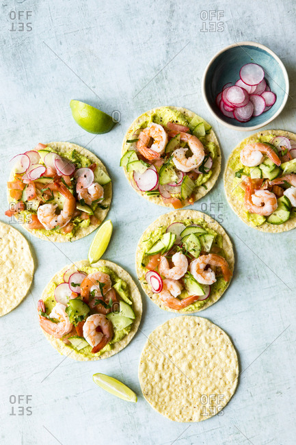 Shrimp tostadas with homemade guacamole, diced tomatoes and radish