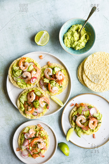 Shrimp tostadas served with homemade guacamole, tomatoes and radish