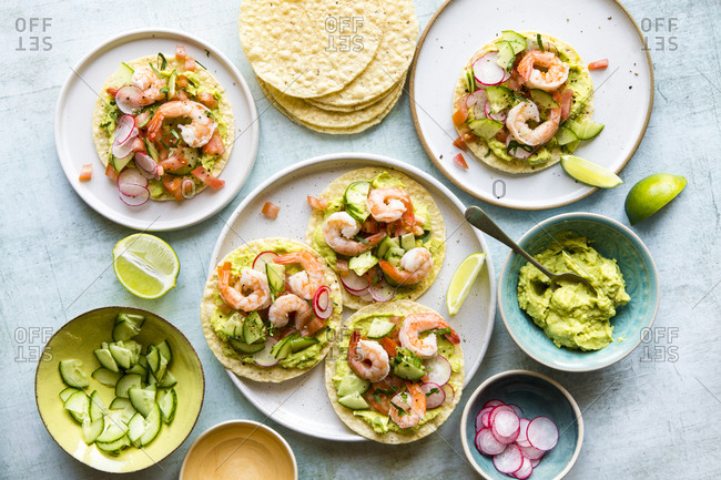 Shrimp tostadas served with guacamole and various toppings